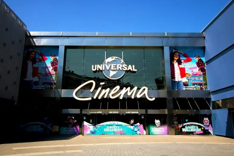 Exterior of a universal cinema building on a sunny day.